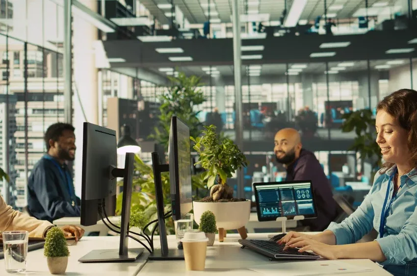 A pleasant, bright, modern corporate office in Los Angeles under natural daylight with logistics professionals working seamlessly on laptops
