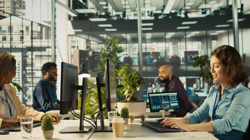 A pleasant, bright, modern corporate office in Los Angeles under natural daylight with logistics professionals working seamlessly on laptops